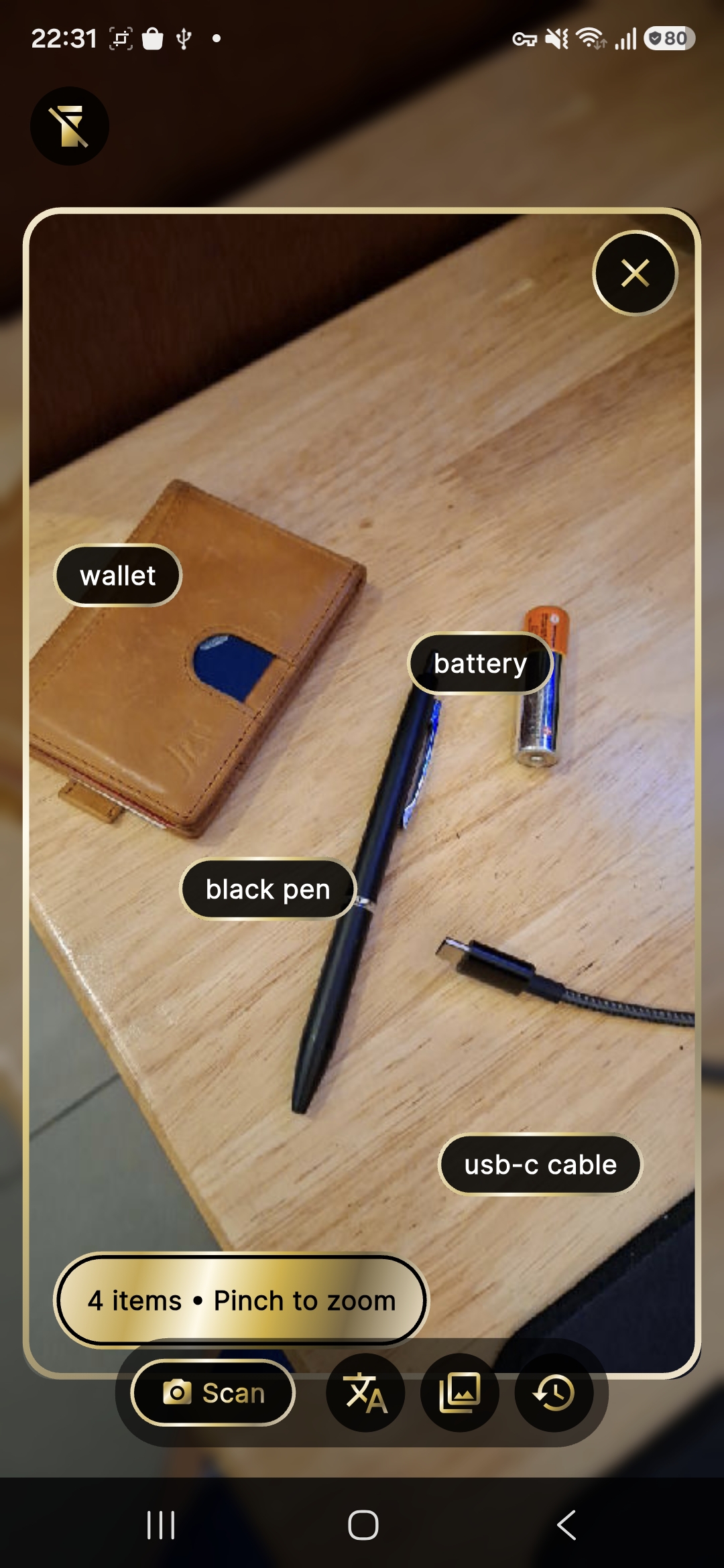 Scan mode: analyzed photo with gold item chips on wallet, pen, battery, and cable